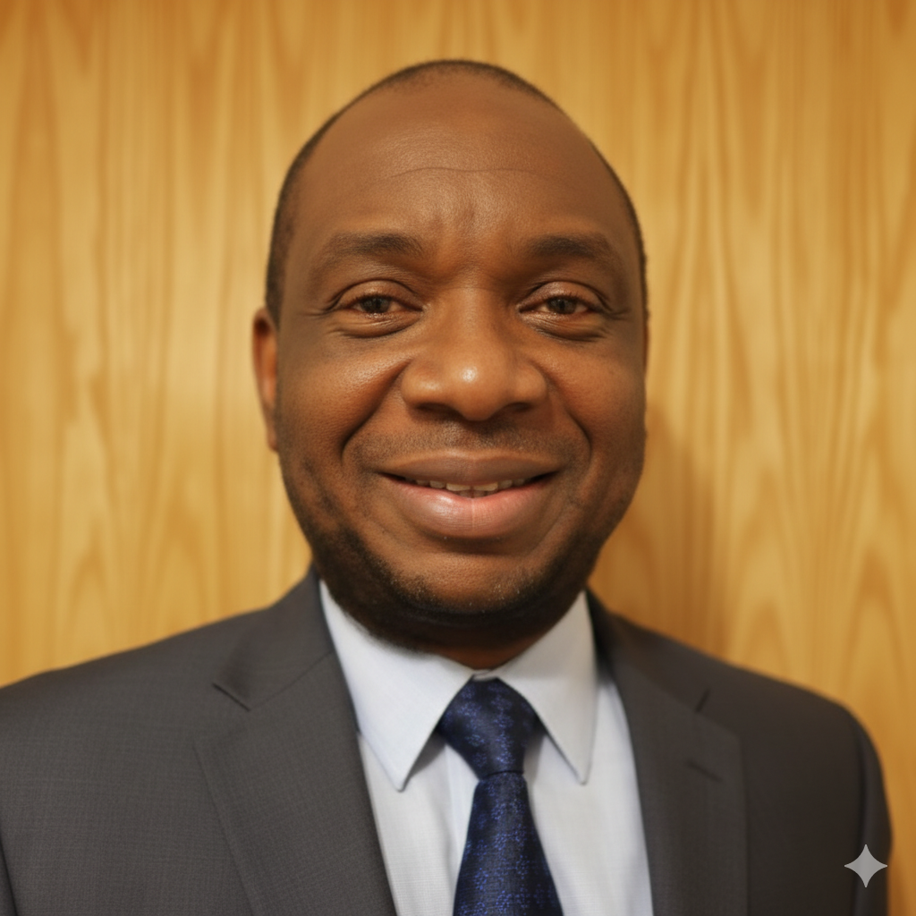 Headshot of Daniel Ukiomogbe , an accredited family mediator in London, wearing a professional suit and tie against a wooden background.